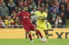 Liverpool's Mohamed Salah, left, is challenged by Villarreal's Pervis Estupinan during the Champions League semi final, first leg soccer match between Liverpool and Villarreal at Anfield stadium in Liverpool, England, Wednesday, April 27, 2022. (AP Photo/Jon Super)