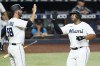 Miami Marlins' Jacob Stallings (58) and Jesus Aguilar congratulate each other after they both scored on a single by Jesus Sanchez during the second inning of a baseball game against the Seattle Mariners, Friday, April 29, 2022, in Miami. (AP Photo/Wilfredo Lee)