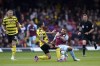 Watford's Kiko Femenia challenges Burnley's Aaron Lennon, right, battle for the ball during the English Premier League soccer match between Watford and Burnley at Vicarage Road, Watford, England, Saturday April 30, 2022. (John Walton/PA via AP)