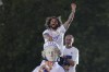 Real Madrid's Captain Marcelo celebrates on top of the Cibeles goddess statue after Real Madrid won the Spanish La Liga title after defeating Espanyol in Madrid, Spain, Saturday, April 30, 2022. (AP Photo/Paul White)