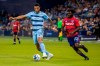 Sporting Kansas City forward Khiry Shelton (11) maneuvers past FC Dallas midfielder Ema Twumasi (22) during an MLS soccer match Saturday, April 30, 2022, in Kansas City, Kan. (Nick Tre. Smith/The Kansas City Star via AP)