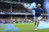Everton's Richarlison ruins with a flare as he celebrates after scoring his sides first goal during the Premier League soccer match between Everton and Chelsea at Goodison Park in Liverpool, England, Sunday, May 1, 2022. (AP Photo/Jon Super)