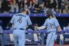 Toronto Blue Jays shortstop Bo Bichette (11) and teammate George Springer (4) celebrate Bichette's two-run home run during the sixth inning of MLB baseball action against the Houston Astros in Toronto on Sunday, May 1, 2022. THE CANADIAN PRESS/Christopher Katsarov