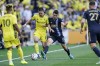 Nashville SC midfielder Alex Muyl (19) is defended by Philadelphia Union's Leon Flach (31) during the first half of an MLS soccer match Sunday, May 1, 2022, in Nashville, Tenn. (AP Photo/Mark Humphrey)