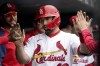 St. Louis Cardinals' Paul Goldschmidt is congratulated by teammates after hitting a solo home run during the first inning of a baseball game against the Kansas City Royals Monday, May 2, 2022, in St. Louis. (AP Photo/Jeff Roberson)