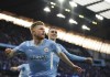 Manchester City's Kevin De Bruyne, front, celebrates after scoring his side's opening goal during the Champions League semi final, first leg soccer match between Manchester City and Real Madrid at the Etihad stadium in Manchester, England, Tuesday, April 26, 2022. (AP Photo/Dave Thompson)