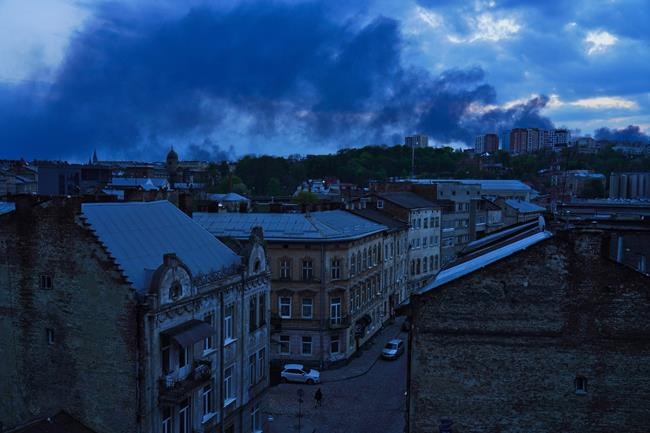 Smoke rises after a Russian missile strike in Lviv, Ukraine, late Tuesday, May 3, 2022. Russian missile strikes targeted the city in western Ukraine on Tuesday, hitting electrical substations and disrupting power. (AP Photo/Jon Gambrell)