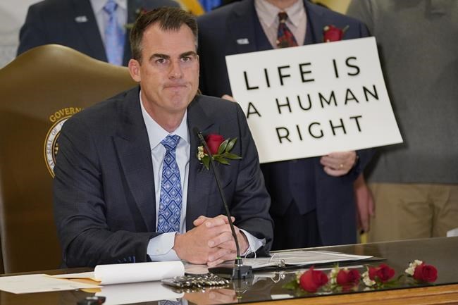 FILE - Oklahoma Gov. Kevin Stitt speaks after signing into law a bill making it a felony to perform an abortion, punishable by up to 10 years in prison on April 12, 2022, in Oklahoma City. Stitt signed a Texas-style abortion ban on Tuesday that prohibits abortions after about six weeks of pregnancy on Tuesday, May 3, 2022. (AP Photo/Sue Ogrocki, File)