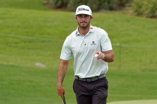 FILE - Max Homa holds up his ball to the gallery after sinking a birdie putt on the second green during the third round of the Arnold Palmer Invitational golf tournament on March 6, 2021, in Orlando, Fla. If Homa still had a podcast, he would tell his listeners that everything is fine, thanks for asking. Homa, the son of a Hollywood acting coach and a three-time winner on the PGA Tour, has strong instincts about fan engagement. He built a big following on social media and then began mercilessly dissecting his own play on the “Get a Grip” podcast with Golf Channel host Shane Bacon. (AP Photo/John Raoux, File)