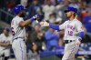 New York Mets' Starling Marte, left, and Francisco Lindor celebrate after Lindor's two-run home run during the ninth inning of a baseball game against the Philadelphia Phillies, Thursday, May 5, 2022, in Philadelphia. (AP Photo/Matt Slocum)