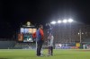 A trainer talks to Minnesota Twins' Carlos Correa, right, after he was hit by a pitch from Baltimore Orioles starting pitcher Spenser Watkins during the fifth inning of a baseball game, Thursday, May 5, 2022, in Baltimore. (AP Photo/Julio Cortez)