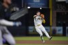 San Diego Padres shortstop Ha-Seong Kim throws to first for the out on Miami Marlins' Miguel Rojas, left, during the seventh inning of a baseball game Friday, May 6, 2022, in San Diego. (AP Photo/Gregory Bull)