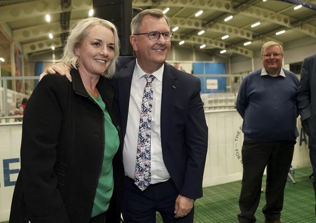 Democratic Unionist Party leader Sir Jeffrey Donaldson congratulates party colleague Pam Cameron on her election at Ulster University Jordanstown count center in Newtownabbey, in North Belfast, Northern Ireland, as counting continues in the Northern Ireland Assembly Election on Friday, May, 6 2022. (Brian Lawless/PA via AP)
