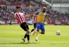 Southampton's Nathan Redmond, right, and Brentford's Christian Norgaard battle for the ball during the English Premier League soccer match between Brentford and Southampton at the Brentford Community Stadium, London, Saturday May 7, 2022. (John Walton/PA via AP)