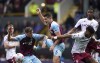 Burnley's Wout Weghorst, left, and James Tarkowski battle for the ball with Aston Villa's Tyrone Mings and Ezri Konsa during the English Premier League soccer match between Burnley and Aston Villa at Turf Moor, Burnley, England, Saturday, May 7, 2022. (Nick Potts/PA via AP)