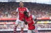 Arsenal's Eddie Nketiah, right, celebrates with teammate Arsenal's Cedric Soares after scoring during the English Premier League soccer match between Arsenal and Leeds United at the Emirates Stadium, in London Sunday, May 8, 2022. (AP Photo/Frank Augstein)