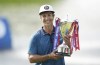 Denmark's Thorbjorn Olesen celebrates winning with the trophy after day four of Betfred British Masters at The Belfry, Sutton Coldfield, Britain, Sunday May 8, 2022. (Zac Goodwin/PA via AP)