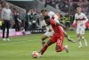 Bayern's Alphonso Davies, front, duels for the ball with Stuttgart's Omar Marmoush during the German Bundesliga soccer match between Bayern Munich and Stuttgart, at the Allianz Arena, in Munich, Germany, Sunday, May 8, 2022. (AP Photo/Michael Probst )