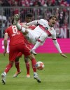 Bayern's Leon Goretzka, left, duels for the ball with Stuttgart's Omar Marmoush during the German Bundesliga soccer match between Bayern Munich and Stuttgart, at the Allianz Arena, in Munich, Germany, Sunday, May 8, 2022. (AP Photo/Michael Probst )