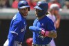 Toronto Blue Jays' Bo Bichette, right, is congratulated by George Springer after scoring a run on a two-RBI single by Teoscar Hernandez in the first inning of a baseball game against the Cleveland Guardians, Sunday, May 8, 2022, in Cleveland. (AP Photo/David Dermer)