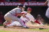 Los Angeles Angels designated hitter Shohei Ohtani (17) scores off of a walk-off single hit by Anthony Rendon during the ninth inningof a baseball game against the Washington Nationals in Anaheim, Calif., Sunday, May 8, 2022. Washington Nationals catcher Riley Adams is at left. (AP Photo/Ashley Landis)