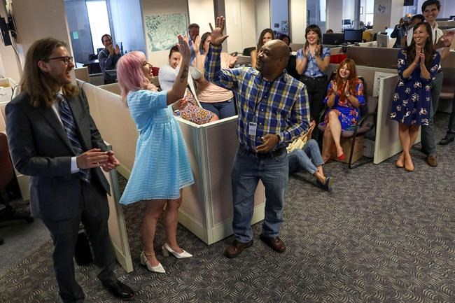 Tampa Bay Times reporters Corey G. Johnson, center, Rebecca Woolington, second left, and Eli Murray, left, are announced as the winners of the Pulitzer Prize for investigative reporting on Monday, May 9, 2022. The winning series,