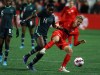 Canada's Quinn is pushed off balance by Nigeria's Onyenaturuchi Ucheibe (14) during second half soccer action during the national team celebration tour at Starlight Stadium in Langford, B.C., Monday, April 11, 2022. Canadian soccer stars Quinn and Erin McLeod are among over 200 members of academic and sport communities that have signed a letter asking Sport Canada to withdraw financial support for a survey they say is discriminatory toward transgender athletes.&nbsp;THE CANADIAN PRESS/Chad Hipolito