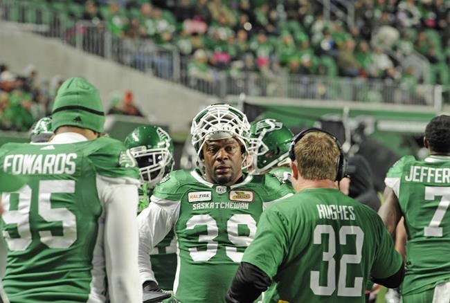 Saskatchewan Roughriders defensive lineman Charleston Hughes talks with head coach Chris Jones on the sidelines during second half CFL action against the B.C. Lions at Mosaic Stadium in Regina on Saturday, Oct. 27, 2018. THE CANADIAN PRESS/Mark Taylor