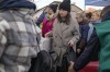 Refugees wait in line after fleeing the war from neighbouring Ukraine at the border crossing in Medyka, southeastern Poland, Friday, April 8, 2022.&nbsp;The federal government has created an online portal for Canadian businesses to donate to Ukrainians who need help to get set up in Canada after fleeing war in their country.THE CANADIAN PRESS/AP/Sergei Grits