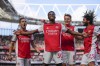 Arsenal's Eddie Nketiah, center, celebrates with teammates after scoring during the English Premier League soccer match between Arsenal and Leeds United at the Emirates Stadium, in London Sunday, May 8, 2022. (AP Photo/Frank Augstein)