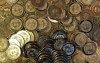 FILE - This April 3, 2013, file photo shows bitcoin tokens in Sandy, Utah. The Cuban government said Thursday, August 26, 2021, that it will start recognizing cryptocurrencies like Bitcoin as payment. With investors eager to get in early on new cryptocurrency projects, some unscrupulous developers have attracted investments, then walked away before building what they promised — leaving their supporters with worthless holdings. The rug pull, which gets its name from the expression “pulling the rug out,” is part of a long history of investment schemes. But cryptocurrencies have particular risks due to loose regulations for fundraising.  (AP Photo/Rick Bowmer, File)