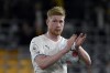 Manchester City's Kevin De Bruyne leaves the field with the match ball at the end of the English Premier League soccer match between Wolverhampton Wanderers and Manchester City at Molineux stadium in Wolverhampton, England, Wednesday, May 11, 2022. De Bruyne scored four goals in Manchester City's 5-1 win. (AP Photo/Rui Vieira)