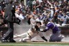 San Francisco Giants' Mike Yastrzemski, center, beats the tag by Colorado Rockies catcher Dom Nunez (3) to score a run on a fielder choice hit by Brandon Crawford during the fourth inning of a baseball game in San Francisco, Wednesday, May 11, 2022. (AP Photo/Tony Avelar)