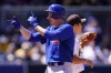 Chicago Cubs' Frank Schwindel reacts after hitting a two-run double as San Diego Padres shortstop Ha-Seong Kim looks to the outfield during the fourth inning of a baseball game Wednesday, May 11, 2022, in San Diego. (AP Photo/Gregory Bull)