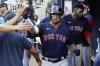 Boston Red Sox third baseman Rafael Devers (11) celebrates in the dugout after scoring on a J.D. Martinez base hit in the third inning of a baseball game against the Atlanta Braves Wednesday, May 11, 2022, in Atlanta. (AP Photo/John Bazemore)
