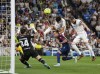 Real Madrid's Karim Benzema, right, scores his side's second goal during a Spanish La Liga soccer match between Real Madrid and Levante at the Santiago Bernabeu stadium in Madrid, Thursday, May 12, 2022. (AP Photo/Manu Fernandez)