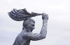 A statue of Manchester City Club legend, Argentinian Sergio Aguero, designed by sculptor Andy Scott outside the Etihad Stadium, to commemorate the tenth anniversary of the Club's first Premier League title and the iconic '93:20' moment in Manchester, England, Friday May 13, 2022. (Martin Rickett/PA via AP)