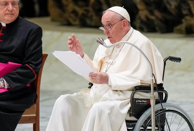 Pope Francis in a wheelchair delivers his address during an audience with members of the Italian Civil Aviation Authority (ENAC) in the Paul VI Hall at The Vatican, Friday, May 13, 2022. Pope Francis suffers from strained ligaments in his right knee. (AP Photo/Andrew Medichini)