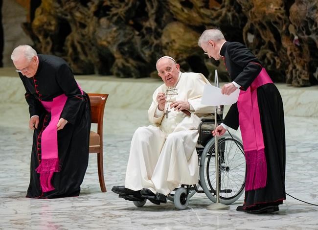 Pope Francis in a wheelchair attends an audience with members of the Italian Civil Aviation Authority (ENAC) in the Paul VI Hall at The Vatican, Friday, May 13, 2022. Pope Francis suffers from strained ligaments in his right knee. (AP Photo/Andrew Medichini)