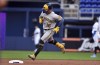 Milwaukee Brewers' Kolten Wong (16) rounds second base after hitting a home run during the first inning of the team's baseball game against the Miami Marlins, Friday, May 13, 2022, in Miami. (AP Photo/Jim Rassol)