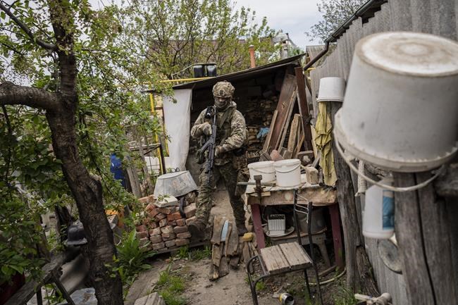 A Ukrainian National Guard soldier patrols during a reconnaissance mission in a recently retaken village on the outskirts of Kharkiv, east Ukraine, Saturday, May 14, 2022. (AP Photo/Bernat Armangue)