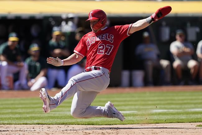 Los Angeles Angels' Mike Trout slides home to score against the Oakland Athletics during the eighth inning of the first baseball game of a doubleheader in Oakland, Calif., Saturday, May 14, 2022. (AP Photo/Jeff Chiu)