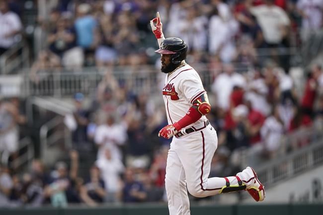 Atlanta Braves' Marcell Ozuna (20) celebrates after hitting a two-run home run in the eighth inning of a baseball game against the San Diego Padres, Saturday, May 14, 2022, in Atlanta. (AP Photo/Brynn Anderson)