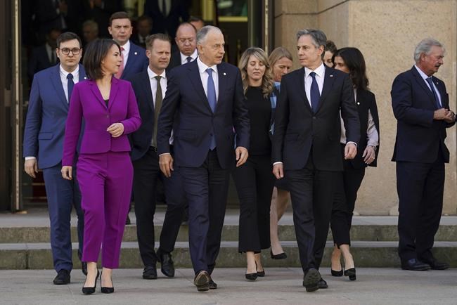 German Foreign Minister Annalena Baerbock, second left, NATO Deputy Secretary General Mircea Geoana, center, and U.S. Secretary of State Antony Blinken, second right, arrive for the group photo at the Informal Meeting of NATO Ministers of Foreign Affair in Berlin, Germany, Sunday May 15, 2022. (Kevin Lamarque/Pool via AP)