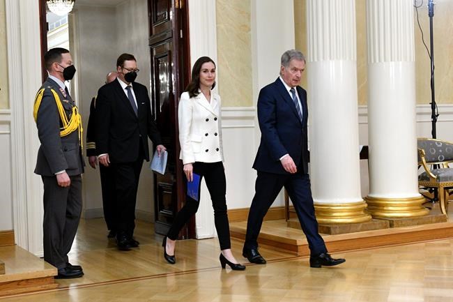Finland's President Sauli Niinisto, right, and Prime Minister Sanna Marin arrive for the press conference on Finland's security policy decisions at the Presidential Palace in Helsinki, Finland, Sunday May 15, 2022. Finland’s president and government have announced that the Nordic country intends to apply for membership in NATO, paving the way for the 30-member Western military alliance to expand amid Russia’s war in Ukraine. (Heikki Saukkomaa/Lehtiuva via AP)