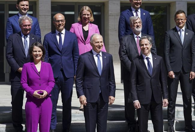 German Foreign Minister Annalena Baerbock, left, NATO Deputy Secretary General Mircea Geoana, front center, and U.S. Secretary of State Antony Blinken, front right, pose for the group photo at the Informal Meeting of NATO Ministers of Foreign Affair in Berlin, Germany, Sunday May 15, 2022. (Kevin Lamarque/Pool via AP)