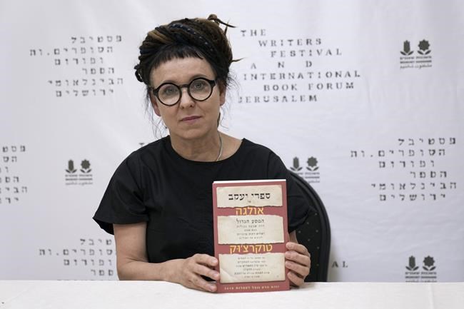 Polish writer and Nobel Prize winner for literature Olga Tokarczuk poses with her book