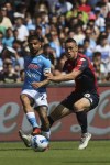 Napoli's Lorenzo Insigne, left, and Genoa's Silvan Hefti battle for the ball during the Serie A soccer match between Napoli and Genoa at Maradona stadium, Naples, Italy, Sunday May 15, 2022. (Alessandro Garofalo/LaPresse via AP)
