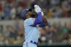 Texas Rangers' Adolis Garcia looks up as he runs the bases after hitting a two-run home run during the sixth inning of a baseball game against the Boston Red Sox in Arlington, Texas, Sunday, May 15, 2022. Rangers' Corey Seager also scored on the play. (AP Photo/LM Otero)