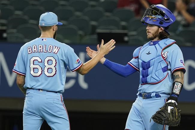 Texas Rangers catcher Jonah Heim, right, congratulates closer Joe Barlow (68) after logging the final out ending the baseball game against the Boston Red Sox in Arlington, Texas, Sunday, May 15, 2022. (AP Photo/LM Otero)